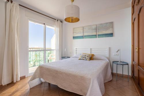 a bedroom with a bed and a large window at Bahia 653 in Nerja