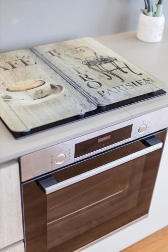 a kitchen counter with a dishwasher in a kitchen at Pestana Apartments - Premium in Porto