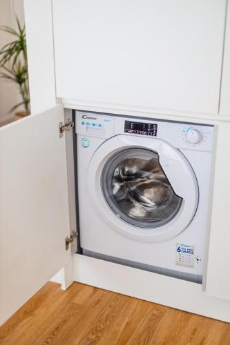 a washer and dryer in a white room at Pestana Apartments - Premium in Porto