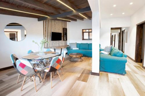 a living room with a blue couch and a table at Casa Miranda 1 in Candelaria