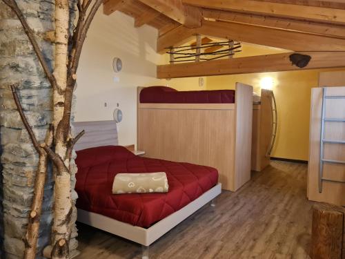 a bedroom with a red bed and a tree at Foresteria Giardino in Paisco