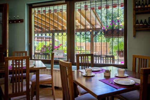 a dining room with a table and chairs and a window at Posada 3 Valles in Liérganes