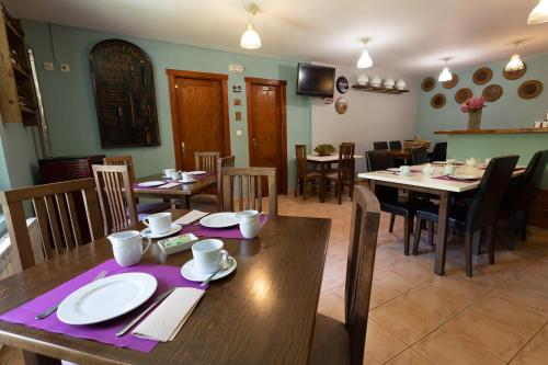 a dining room with a wooden table and chairs at Posada 3 Valles in Liérganes