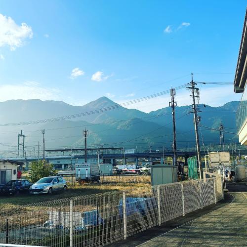 a view of a parking lot with mountains in the background at ペンションレークサイド in Otsu