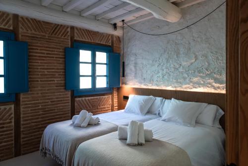 two beds in a room with blue windows at Houmi Orzán in A Coruña