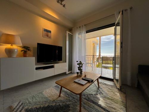 a living room with a television and a coffee table at Lux Cascais Ocean View in Parede