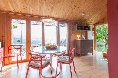 a kitchen and dining room with a table and chairs at GoToGeres - Casa da Piscina - Casas de Alem in Arcos de Valdevez