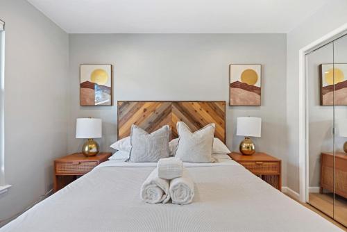 a bedroom with a large white bed with two lamps at @ Marbella Lane - Chic Abode w/Mountain Skyline in Pacifica