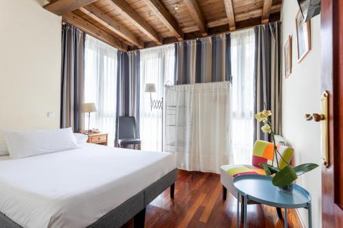 a hotel room with a bed and a table and a chair at Posada 3 Valles in Liérganes