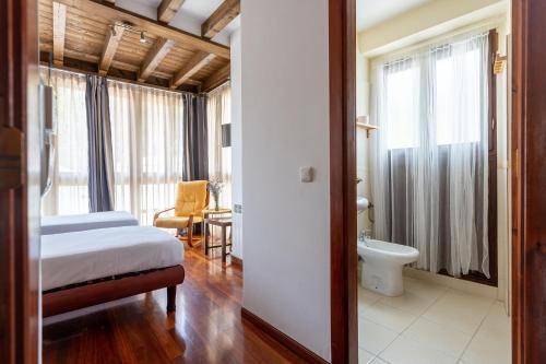 a hotel room with a bed and a bathroom at Posada 3 Valles in Liérganes