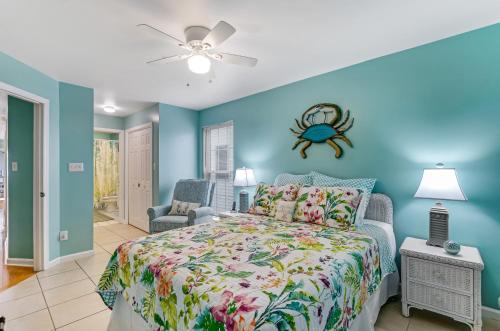 a bedroom with a bed with a spider on the wall at South Beach Views in Tybee Island