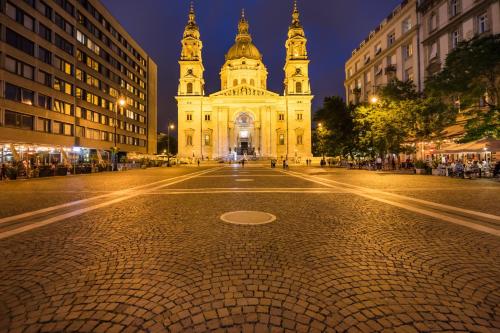 an empty street in front of a building at night at The Pearl of the Heart of Budapest in Budapest