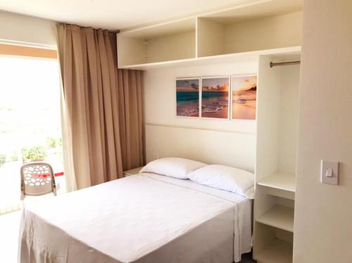 a small bedroom with a bed and a window at Fortaleza Sul Flats Service in Fortaleza