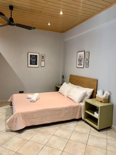 a bedroom with a bed and a night stand at Beautiful apartment Athens Keramikos in Athens