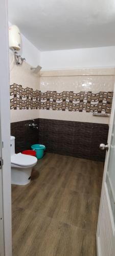 a bathroom with a toilet and a sink at RED LION in Varkala