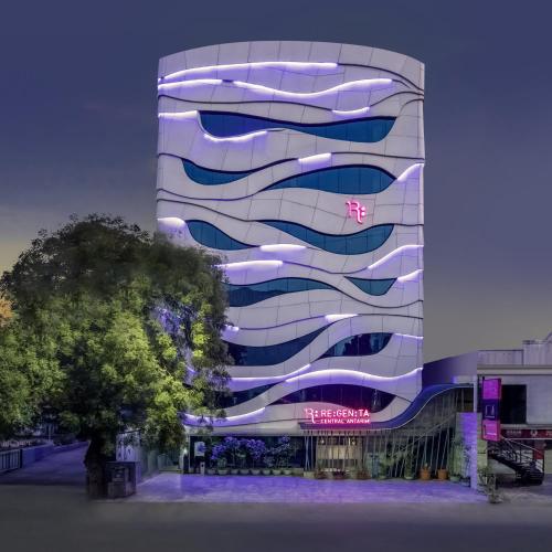 a building with a sign on the side of it at Regenta Central Antarim Ahmedabad in Ahmedabad