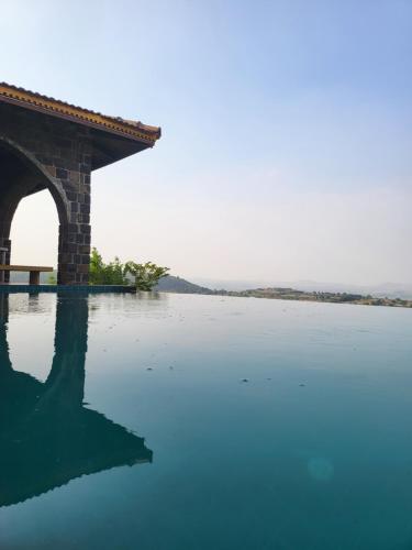 a bridge over a large body of water at EZE NOF - A hilltop villa with 360º water view in Nashik