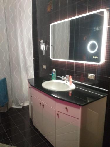a bathroom with a sink and a mirror at Executive center rooms in Bari