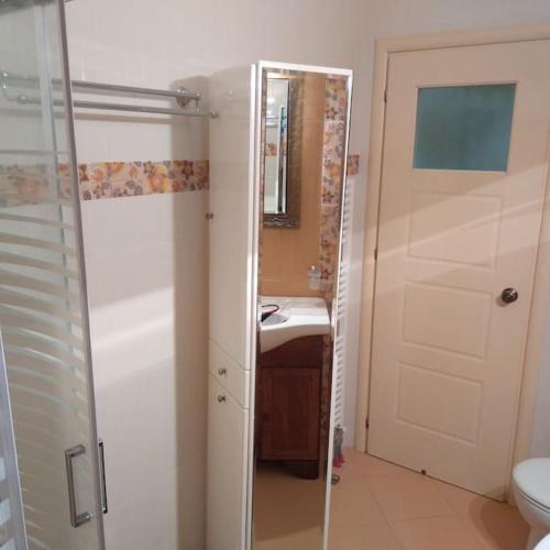 uma casa de banho com um chuveiro, um lavatório e um WC. em Ευρύχωρο διαμέρισμα σε ήσυχη γειτονιά em Kalamata