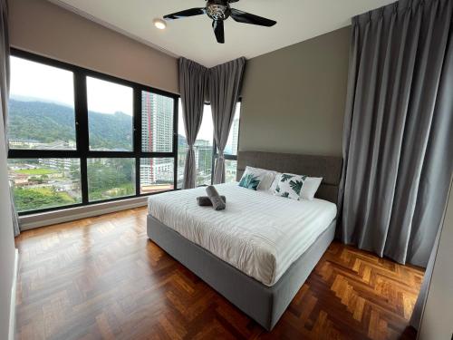 a bedroom with a bed and a ceiling fan at Cozy 2 Bedroom Suite Vista Genting FREE WIFI in Genting Highlands