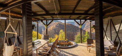 a view from the porch of a house with a mountain view at Amonte Mountain Resort in Muntele Rece