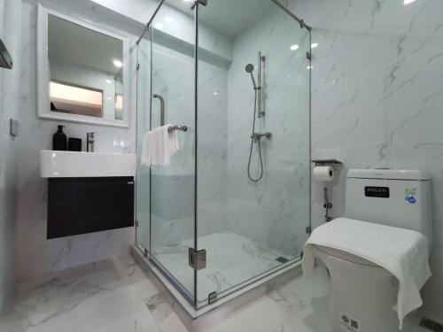 a bathroom with a shower and a toilet and a sink at ABC@48 Hotel & Service Apartment in Bangkok