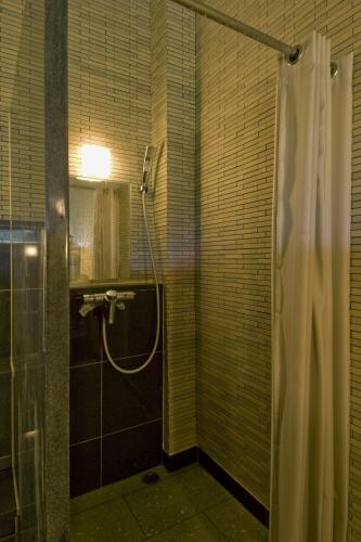 a bathroom with a shower with a shower curtain at Nikko Tokanso in Nikko