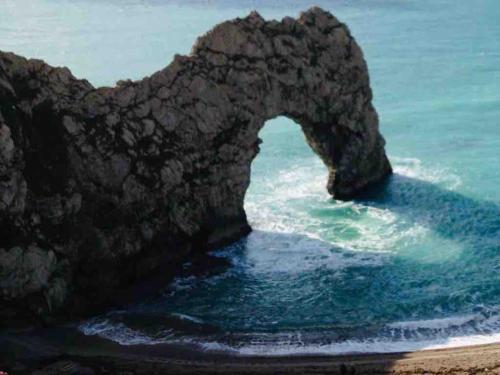 a rock arch in the water near the ocean at The Cabin in Preston