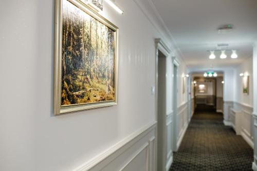 a hallway with a painting on the wall at Muller Hotel Boutique & Spa in Galaţi
