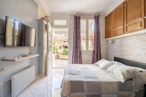 1 dormitorio con cama y ventana grande en Studio idéal pour deux voyageurs sur Marseille en Marsella