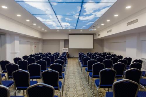a conference room with chairs and a screen at Muller Hotel Boutique & Spa in Galaţi