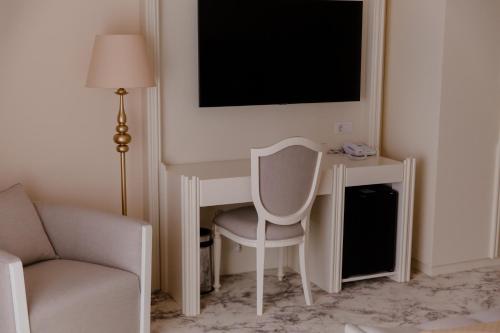 a white computer desk with a chair and a monitor at Muller Hotel Boutique & Spa in Galaţi