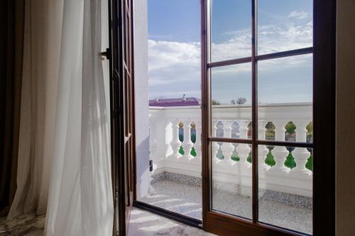 an open window with a view of a white fence at Muller Hotel Boutique & Spa in Galaţi