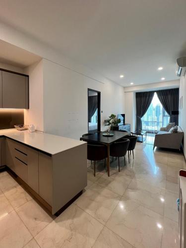 a kitchen and living room with a table and chairs at Opus Residence KL by EUcation Home in Kuala Lumpur