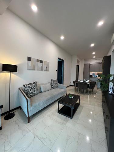 a living room with a couch and a table at Opus Residence KL by EUcation Home in Kuala Lumpur