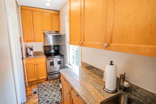 a kitchen with wooden cabinets and a counter top at Downtown Annapolis King George 3rd Floor Hideaway in Annapolis