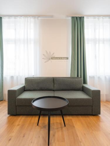 a living room with a couch and a coffee table at Luma Terra Prague Hostel in Prague