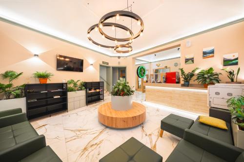 a lobby with a waiting room with plants at Luma Terra Prague Hostel in Prague