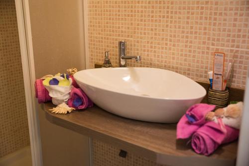 a white sink sitting on a counter in a bathroom at Acqua Azzurra in Alghero