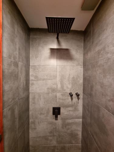 a bathroom with a shower with two birds on the wall at Compass House in Las Palmas de Gran Canaria