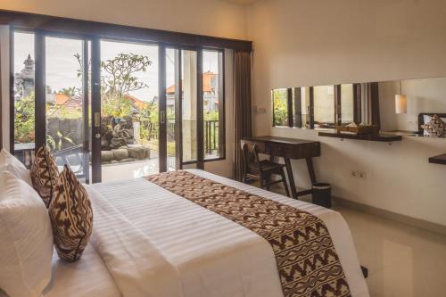 a bedroom with a large bed and a window at Divara Ubud in Ubud