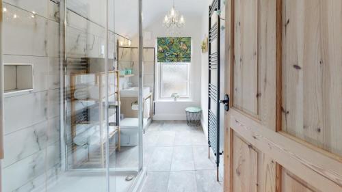 a bathroom with a toilet and a glass door at Princely House Corporate, business & family Home in Mansfield