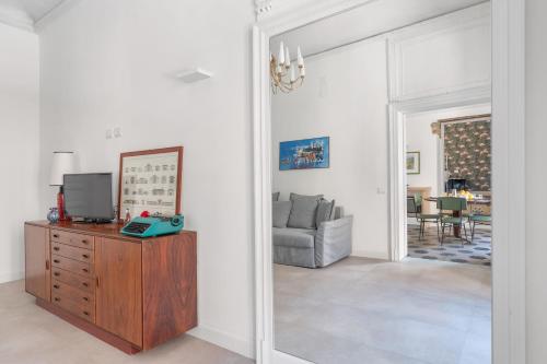 a living room with a mirror and a television at 124 Maqueda Apartments in Palermo
