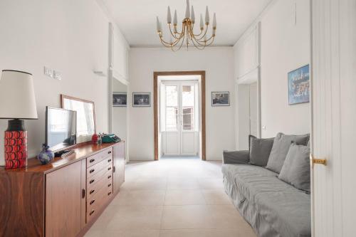 a living room with a couch and a tv at 124 Maqueda Apartments in Palermo