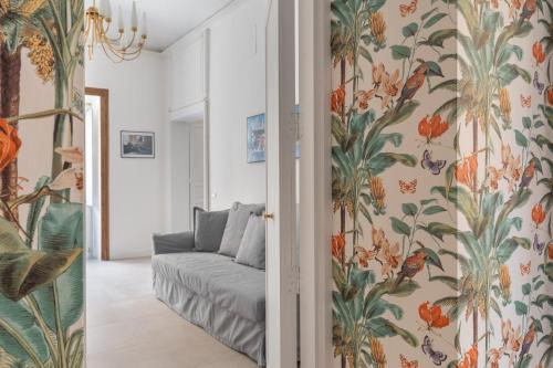 a living room with a couch and floral wallpaper at 124 Maqueda Apartments in Palermo