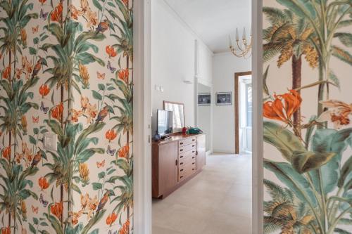 a hallway with a tropical wallpaper at 124 Maqueda Apartments in Palermo