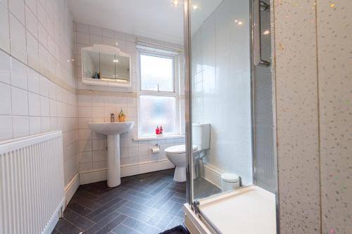 a bathroom with a toilet and a sink and a shower at Oak Room in Liverpool