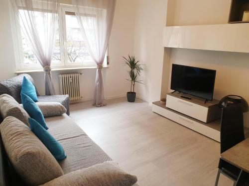 a living room with a couch and a flat screen tv at J&M HOUSE -Fronte Ospedale- in Udine