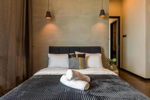 a bedroom with a bed with two towels on it at Opus Residence KL by EUcation Home in Kuala Lumpur