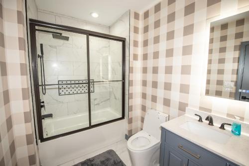 a bathroom with a shower and a toilet and a sink at Dawsonville Retreat in Dawsonville